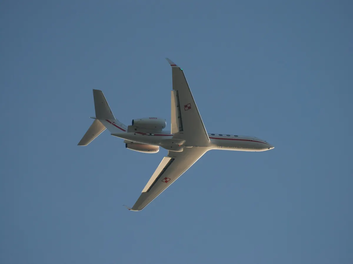 Light business jet overhead against a blue sky
