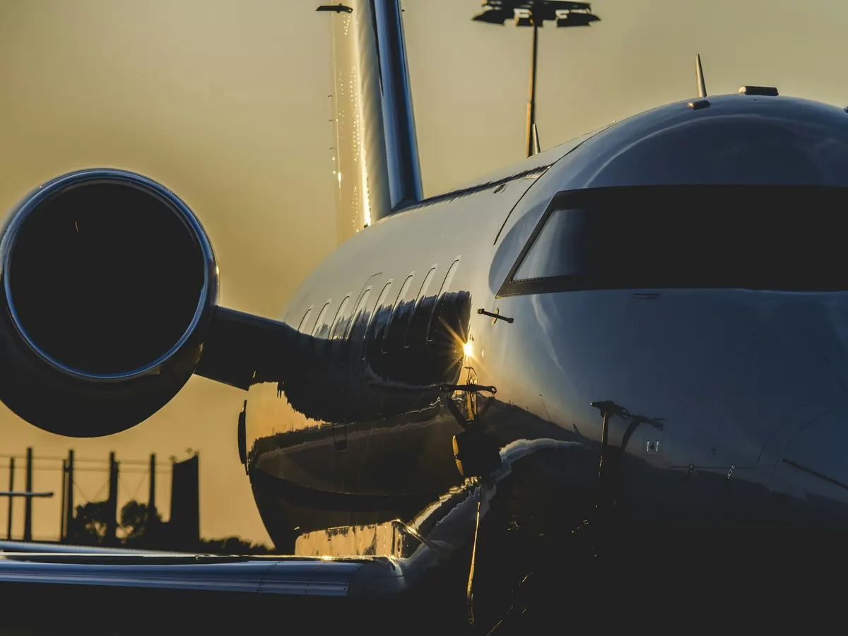 Business jet fuselage and engine in golden light
