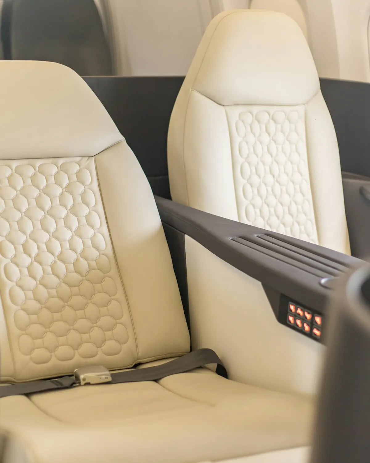 Cream leather seat beside a cabin window