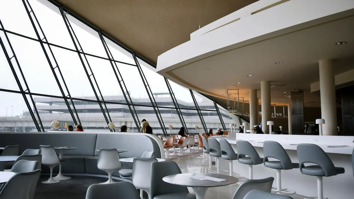 Airport lounge with tall windows onto the apron