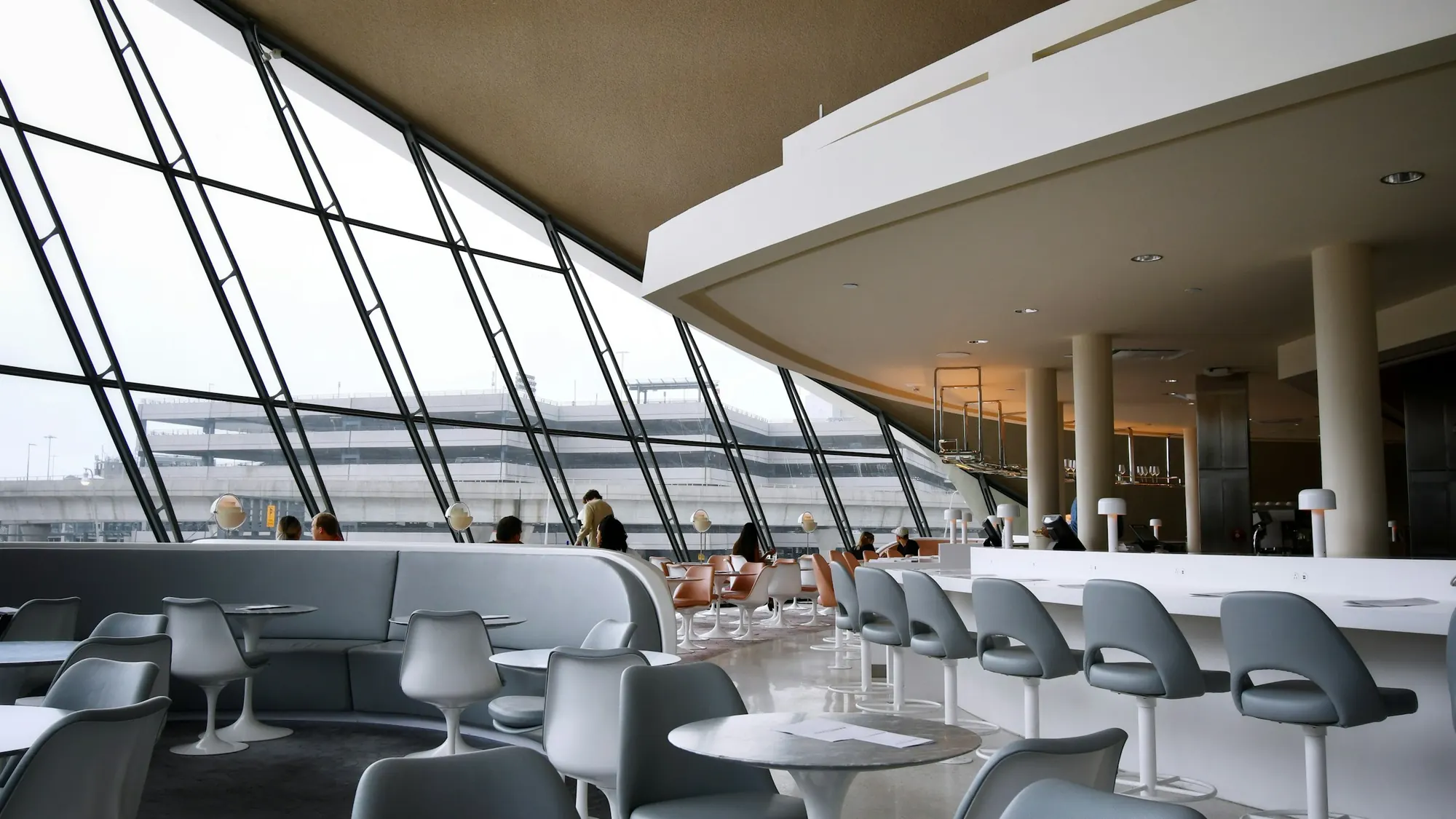Airport lounge with tall windows onto the apron